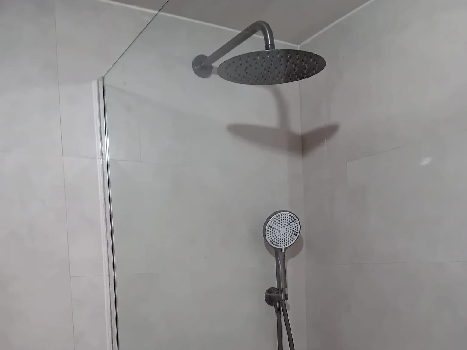 Ducha con rociador de lluvia y teléfono en negro, instalados por MS Reformas